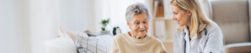 senior health professional chats with senior resident