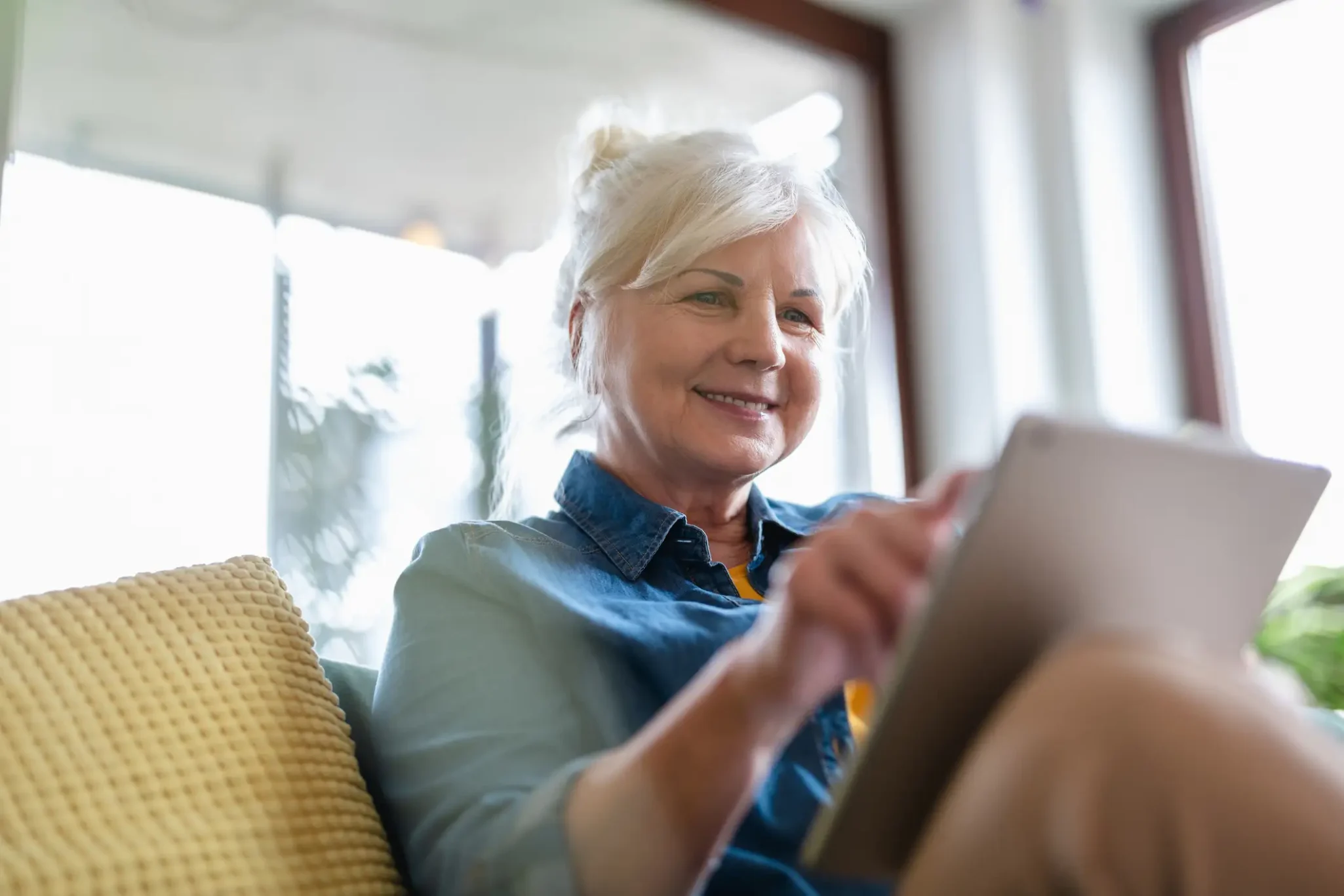 Senior woman viewing a TED Talk on her tablet
